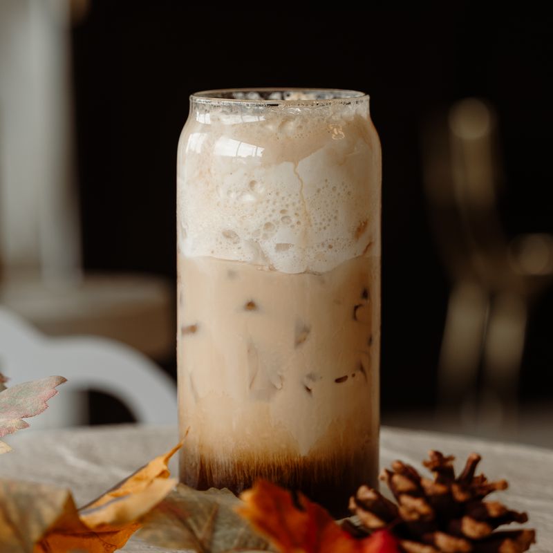 Calabaza Latte with fall leaves and a pinecone